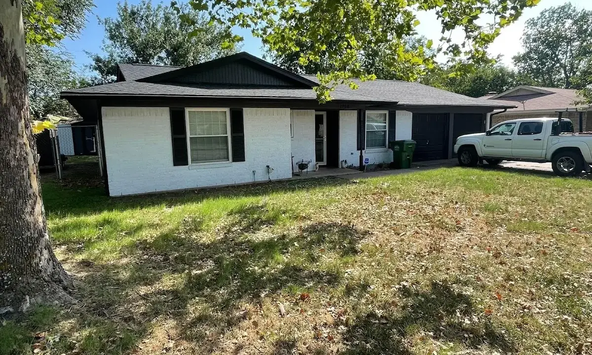 Professional roofing crew working on a residential roof in Kirby